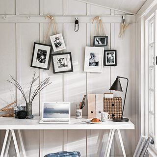 office with white wall and hanging cluster photo frame