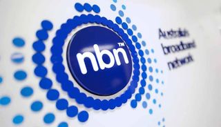 Navy blue NBN Co logo on white wall blurring into background