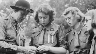 Princess Elizabeth learns to tie a knot with the girl guides in Frogmore, Windsor, England on April 11, 1942.