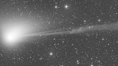 A still image of the green comet C/2022 E3 as a solar explosion rips part of its tail away
