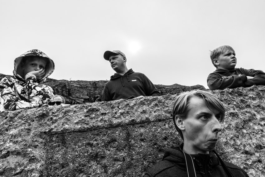 Photograph titled Between the Lines, a candid, comedic black and white picture of a family at &amp;Oslash;rnevegen (Eagle Road) in Norway, showing their humorous facial expressions as they admire the view. Captured by Giulia Pissagroia of Italy and the winner of the Street Photography category in the Open Competition of the Sony World Photography Awards 2026