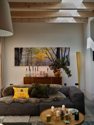 living room with grey sofa and colored christmas candles