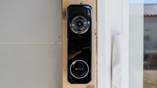 A Wyze Battery Video Doorbell mounted on a door frame