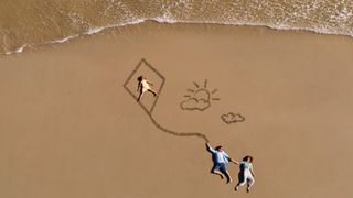 Aerial photo of a family on a beach, taking using DJI Mini 2 drone