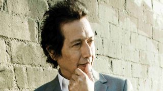 Alejandro Escovedo posing for a photograph in 2010