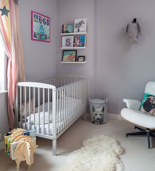lilac nursery with white cot and nursery chair