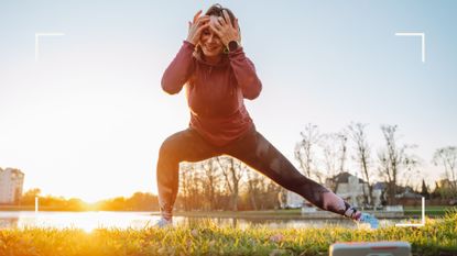 Woman working out with one of the best health apps in a grassy garden space, with phone propped up to follow along with exercise class
