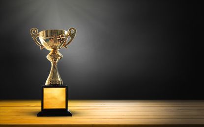 Champion golden trophy on wooden table background. copy space for text.