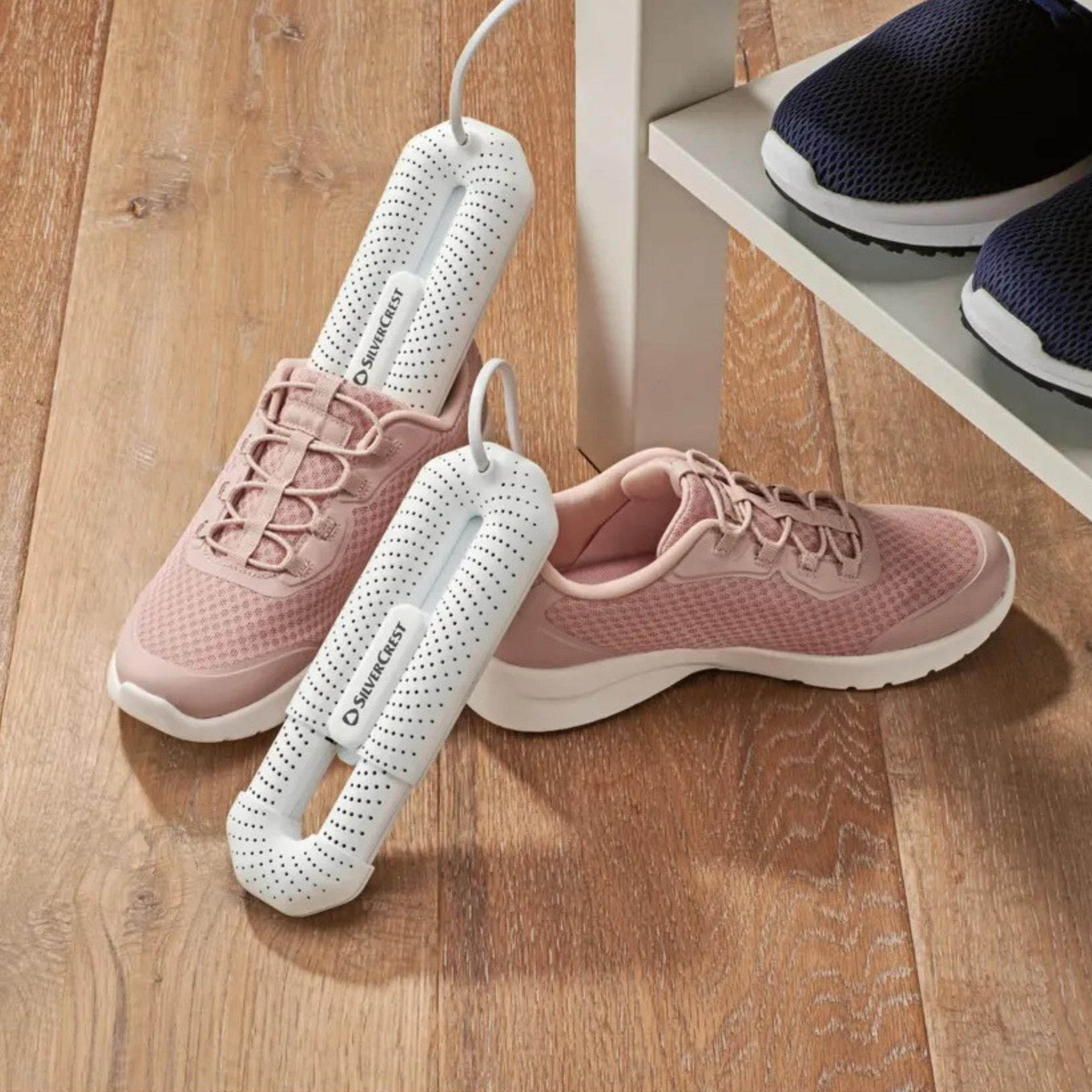 Lidl electric shoe dryer in a pair of pink trainers.