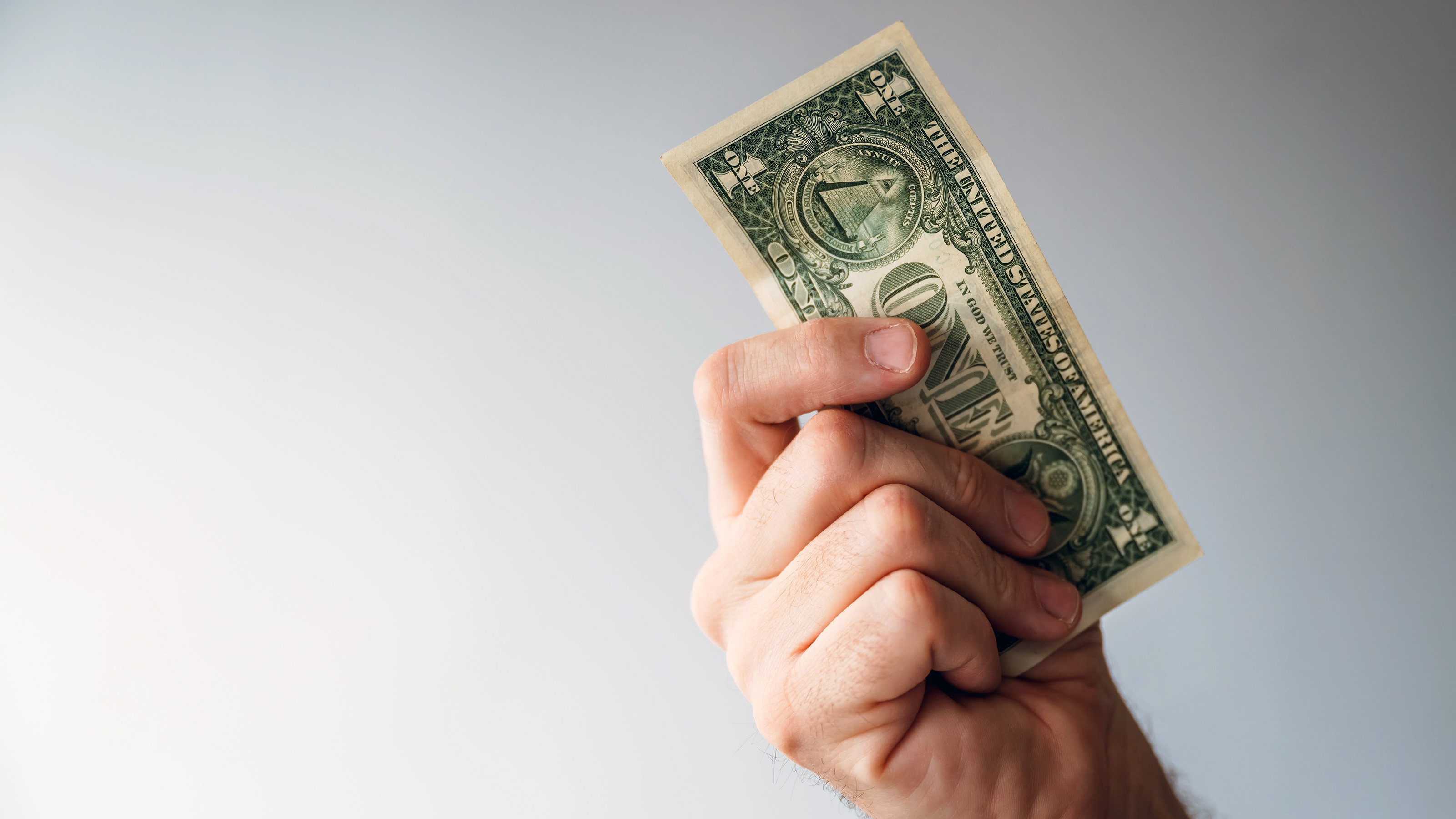  hand holding dollar bill