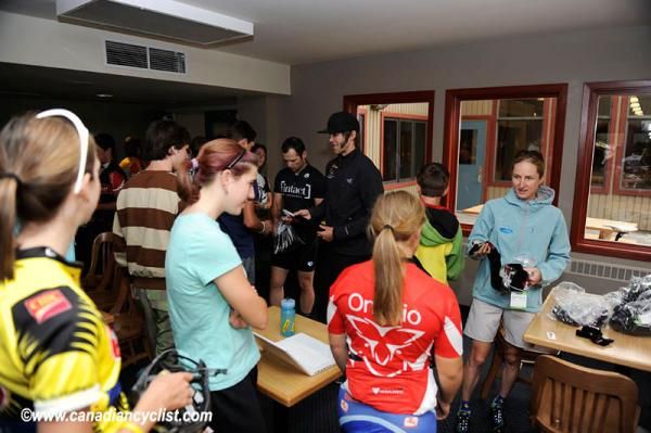 Geoff Kabush and Catharine Pendrel hand out Race Clean kit after talking to young riders.