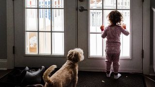 toddler comforting dog during a thunderstorm