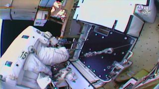 NASA astronaut Andrew Morgan works to install a battery adapter plate during a spacewalk to upgrade the International Space Station’s power system on Sunday, Oct. 6, 2019.