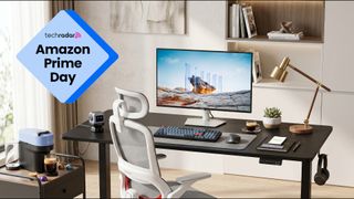 A brightly lit home office packed with chair, monitor, standing desk, and gadgets, with a TechRadar badge in the upper left corner that reads 'Amazon Prime Day'