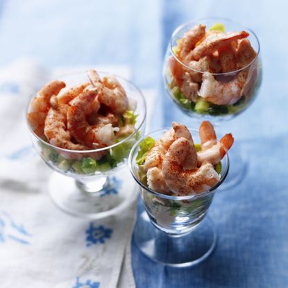 Prawn Cocktail served in glass dishes on a blue tablecloth 