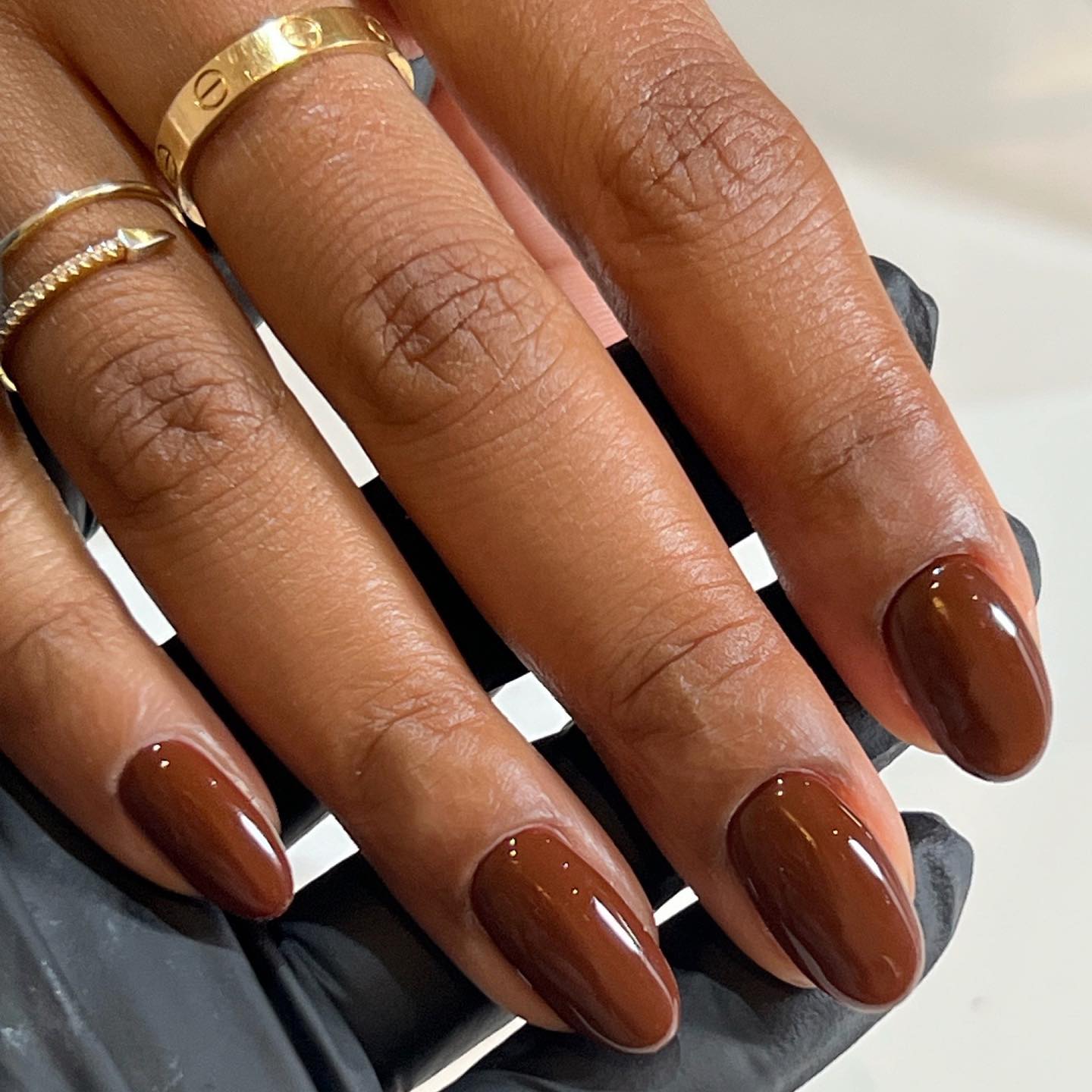 Glossy brown nails.