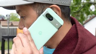 Tom's Editor John Velasco making a phone call with Google Pixel 8a.