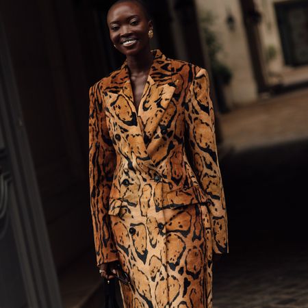 Woman wearing animal print jacket and skirt set