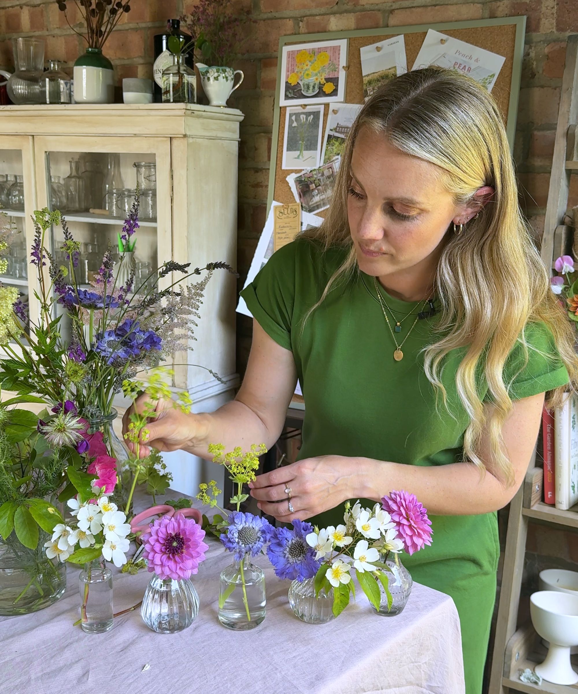 Rachel Bull arranging wild flowers in bud vases