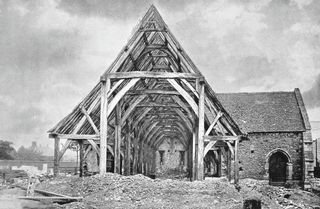 One of two tithe barns in Peterborough undergoing demolition. Photograph first used in Country Life magazine on 6 May 1899. The barn was in good repair, but was pulled down by the Church Commissioners to create land for development. Photo: Country Life Picture Library