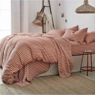Sandstone Red Pembroke Stripe Linen Bundle on a bed.