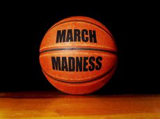 March Madness basketball on a hardwood court