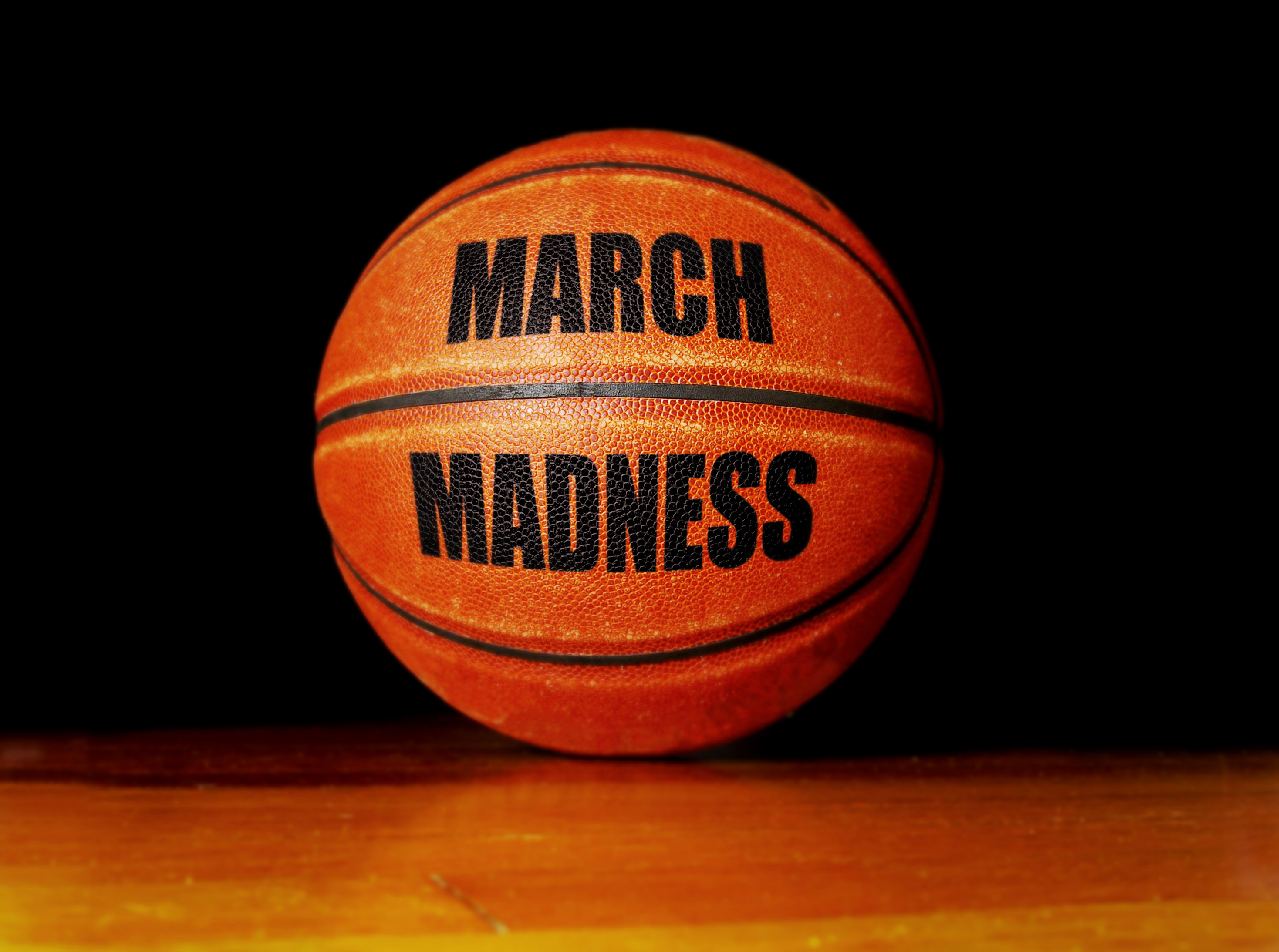March Madness basketball on a hardwood court