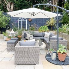 outdoor space with white umbrella shade and plants in pots