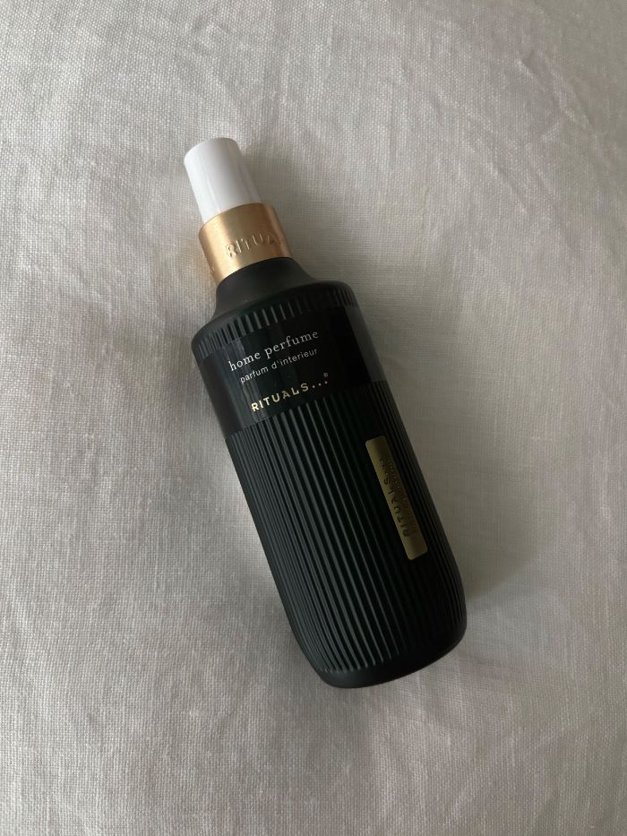 A Rituals room spray on a white linen background