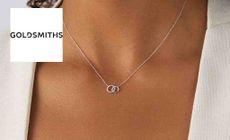 Goldsmiths logo placed over an image of a woman wearing a delicate necklace