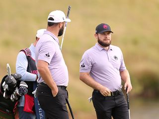 LIV Golf teammates Tyrrell Hatton and Jon Rahm talking on the golf course