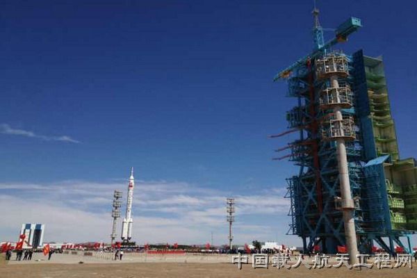 China Long March 2F rocket rolls out to launch pad for Shenzhou 9 mission in June 2012.