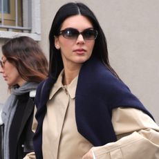 Kendall Jenner was spotted at Milan Fashion Week wearing wide-leg white pants, a Burberry trench coat, and the high-vamp flats trend