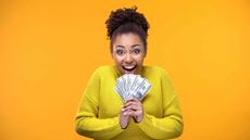 picture of a happy woman holding money