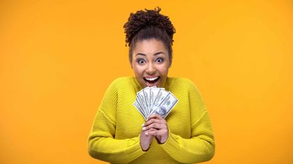 picture of a happy woman holding money