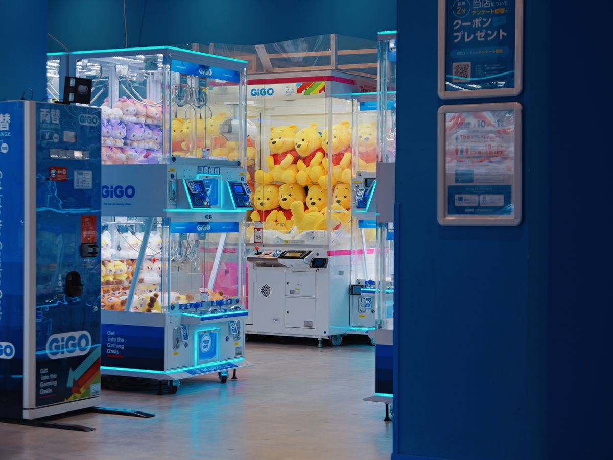 Claw machines filled with plush toys in a Japanese arcade.