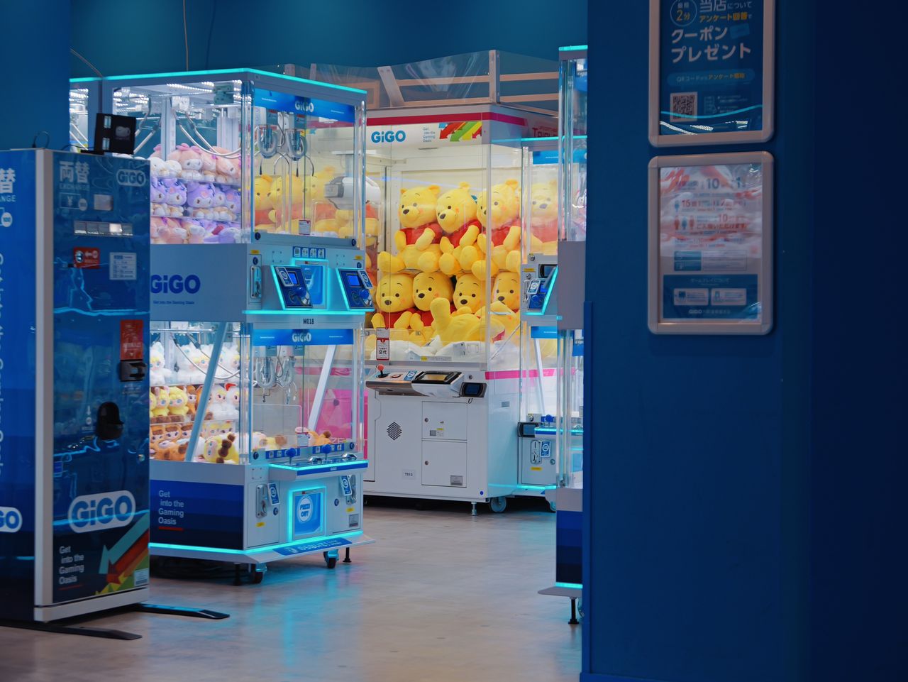 Claw machines filled with plush toys in a Japanese arcade.