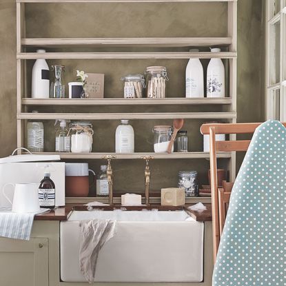 white washbasin with wooden shelves and cabinet