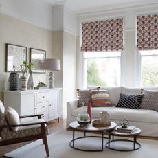 Neutral living room with patterned blinds on windows