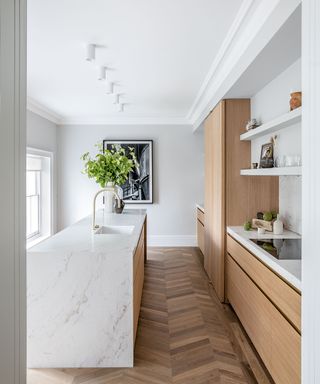 Oak cabinet kitchen with oak floor and white walls