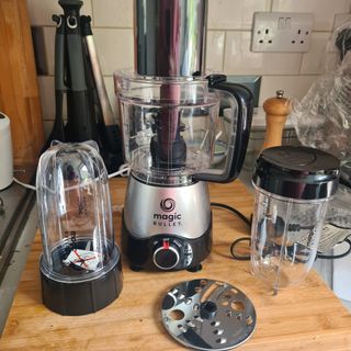 Magic Bullet food processor with all parts displayed on a kitchen counter