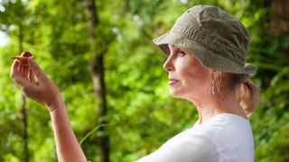 Profile view of Joanna Lumley holding a nutmeg kernel in Indonesia for Joanna Lumley's Spice Trial Adventure