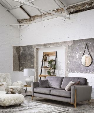 Grey living room with Ercol Marinello Small Fabric Sofa, £1,500, Oyster Bay Accent Chair, £695, Earth Ladder Shelving Unit, £499