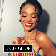 Tiffany Boone stands in front of her hotel suite door wearing a beaded Balmain dress