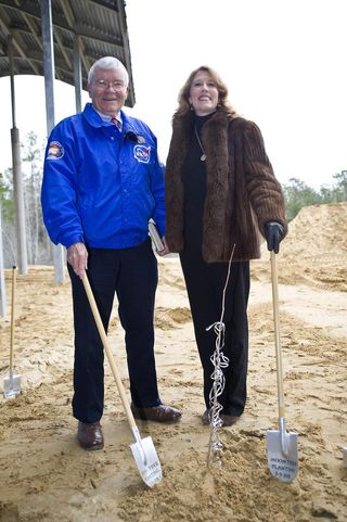 Fred Haise standing next to Rosemary Roosa, daughter of late Apollo 14 astronaut Stuart Roosa, beside a "moon tree" planted at the INFINITY Science Center on Feb. 3, 2011. The moon tree is a descendent of seeds carried into space by Stuart Roosa on the Apollo 14 mission in 1971.