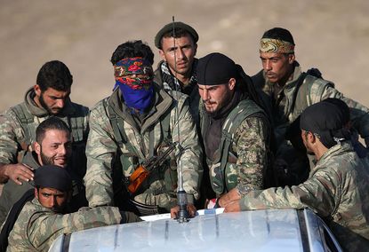 Fighters with the Syrian Democratic Forces are fighting ISIS with U.S. munitions