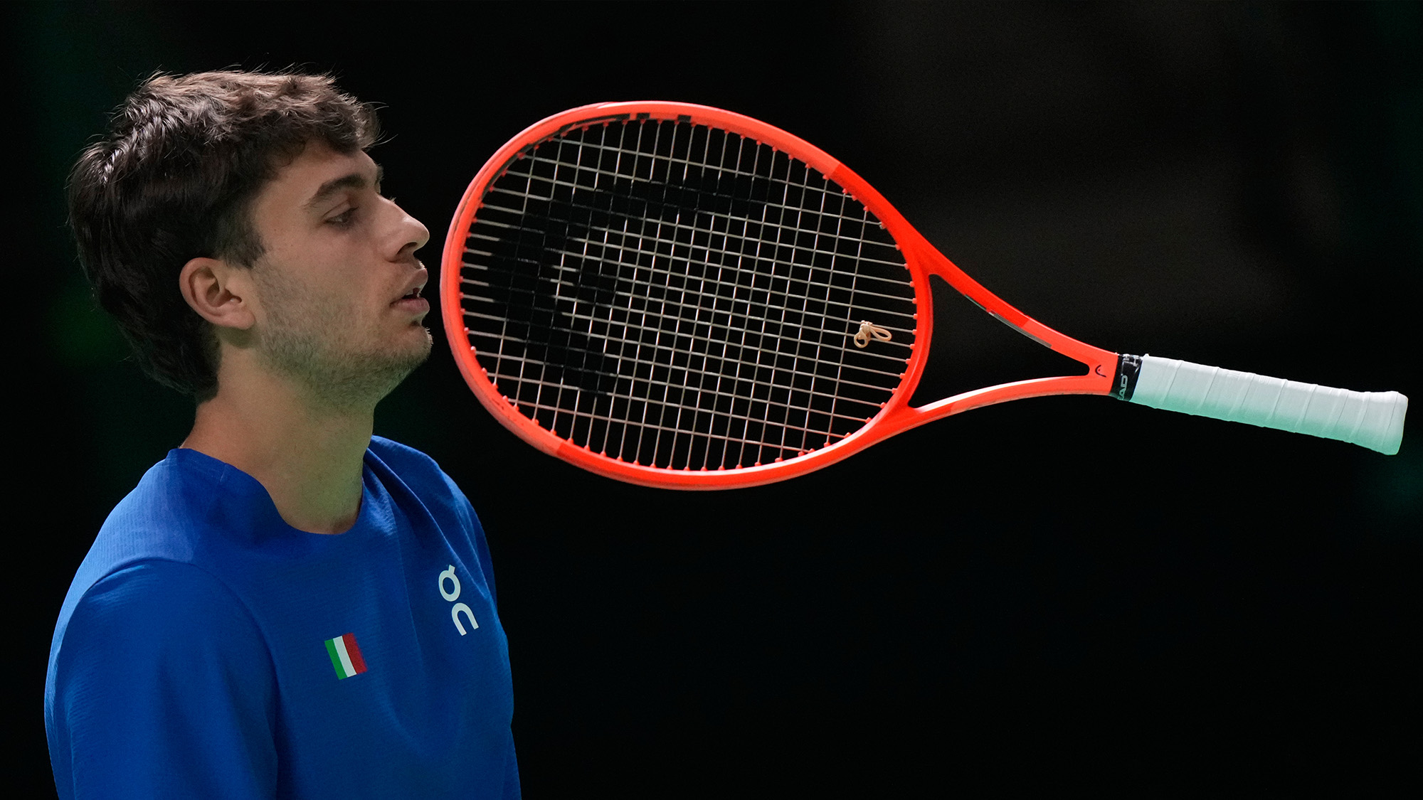 Flavio Cobolli throws his tennis racket during a Davis Cup match in Bologna, Italy
