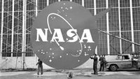 An oversized NASA logo is prepared for installation on the front of a hangar at NASA's Lewis Research Center (today, NASA Glenn) in 1962. 