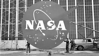 An oversized NASA logo is prepared for installation on the front of a hangar at NASA's Lewis Research Center (today, NASA Glenn) in 1962.