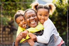 Grandmother hugging two granddaughters